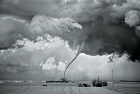 A twister formed by a supercell nears its final stage, known as a “rope out” when it takes this shape. Photo by Mitch Dobrowner | published in Scientific American. 