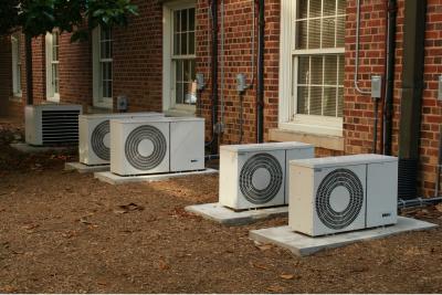 Image of air conditioning units outside of a residential building.
