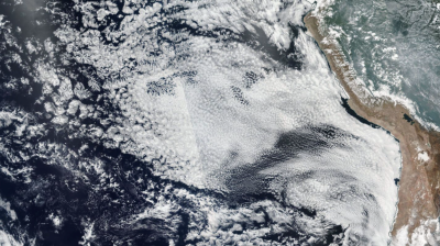 Satellite image of clouds above the ocean and land