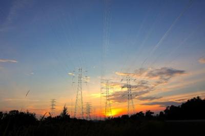 Photograph of power lines in front of a sunset
