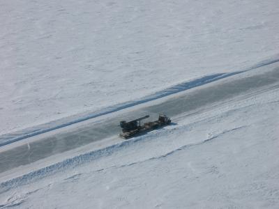 Photograph of a truck on an icy road. (Image by Garry Timco | Wikipedia)