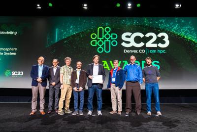 Members of the 19-author team of the Simple Cloud Resolving E3SM Atmosphere Model (SCREAM) present at the Gordon Bell Awards ceremony at the SC23 in Denver on November 16, 2023. From left: Awards presenters Yannis Ioannidis (President of the Association of Computing Machinery [ACM) and ACM Fellow Manish Parashar. SCREAM team: Peter Caldwell (SCREAM team lead), Sarat Sreepathi, Mark Taylor (lead author), James White, Noel Keen, and Luca Bertagna. (Photo: SC Photography)
