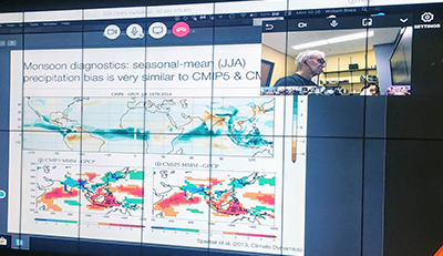 PNNL atmospheric scientist Phil Rasch (upper right) analyzes atmospheric model results while UC Berkeley associate professor William Boos presents monsoon diagnostics from CMIP6 results compared with those from CMIP5 models.