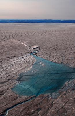 Lake on surface of Greenland Ice Sheet draining through a half mile of ice.